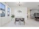 Elegant dining area with modern lighting, stylish decor, and seamless flow to the kitchen at 10034 E Thunderbolt Ave, Mesa, AZ 85212