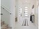 Elegant entryway with white tile flooring, a stylish console table, and contemporary wall decor at 10034 E Thunderbolt Ave, Mesa, AZ 85212
