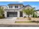 Charming two-story home featuring a modern garage door, low-maintenance landscaping, and a neutral color palette at 10034 E Thunderbolt Ave, Mesa, AZ 85212