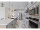 Modern kitchen featuring gray cabinets, stainless appliances, and a stylish island with a white countertop at 10034 E Thunderbolt Ave, Mesa, AZ 85212
