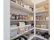 Organized pantry with shelving stocked full of labeled containers and baskets for optimal storage at 10034 E Thunderbolt Ave, Mesa, AZ 85212