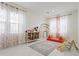 Bright playroom with rainbow wall art, a cozy rug, and large windows, perfect for activities at 10034 E Thunderbolt Ave, Mesa, AZ 85212