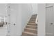 Bright staircase with plush carpet, white walls, and doors leading to various rooms at 10034 E Thunderbolt Ave, Mesa, AZ 85212
