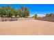Expansive backyard with a neutral colored gravel, framed by a tall block wall for privacy at 1018 E Knoll St, Mesa, AZ 85203