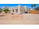 A stylish home with a two-car garage, a desert landscaped front yard, and a privacy fence at 1018 E Knoll St, Mesa, AZ 85203