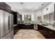 Bright kitchen showcasing stainless steel appliances and dark modern cabinets at 1018 E Knoll St, Mesa, AZ 85203