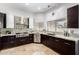 Modern kitchen featuring stainless steel appliances, dark cabinetry, and granite countertops at 1018 E Knoll St, Mesa, AZ 85203