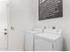 Bright laundry room with a large washer and dryer and a decorative accent at 1018 E Knoll St, Mesa, AZ 85203