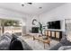 Cozy living room with a fireplace, tile floors, a ceiling fan, and a sliding glass door at 1018 E Knoll St, Mesa, AZ 85203