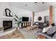 Comfortable living room with a fireplace, tile floors, a ceiling fan, and stylish furnishings at 1018 E Knoll St, Mesa, AZ 85203