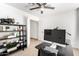 Minimal office space with a large monitor, dark shelves, and neutral walls at 1018 E Knoll St, Mesa, AZ 85203