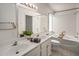 Spacious bathroom with dual sinks, bathtub, and shower combo with bright lighting at 1095 W Sandy Banks --, Gilbert, AZ 85233