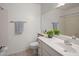 Bright bathroom features neutral tile flooring, vanity and a large mirror at 1095 W Sandy Banks --, Gilbert, AZ 85233