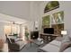 The well-lit living room showcases a fireplace, large windows, and stylish furnishings at 1095 W Sandy Banks --, Gilbert, AZ 85233