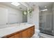 Modern bathroom with skylight, glass-enclosed shower, and sleek vanity with wooden cabinetry at 110 W Missouri Ave # 18, Phoenix, AZ 85013