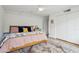 Bedroom features a white brick wall, wood floors, and a plush bed with stylish pillows at 110 W Missouri Ave # 18, Phoenix, AZ 85013
