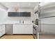 Sleek kitchen with stainless steel appliances, white cabinetry, and functional layout at 110 W Missouri Ave # 18, Phoenix, AZ 85013