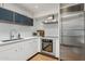Modern kitchen featuring stainless steel appliances, white cabinets, and sleek countertops at 110 W Missouri Ave # 18, Phoenix, AZ 85013