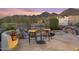 Backyard patio featuring a waterfall and mountain views at dusk at 11462 E Kora Way, Scottsdale, AZ 85255