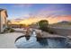Beautiful backyard pool and patio area with waterfall feature and stunning sunset views at 11462 E Kora Way, Scottsdale, AZ 85255