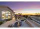 Backyard patio with waterfall, seating area, and view of the home's interior at 11462 E Kora Way, Scottsdale, AZ 85255