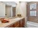 Cozy bathroom featuring decorative tiling, a glass-enclosed shower, and vanity storage at 11462 E Kora Way, Scottsdale, AZ 85255