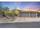 Charming single-story home featuring a three-car garage and xeriscaped front yard at 11462 E Kora Way, Scottsdale, AZ 85255