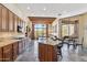 Spacious kitchen with granite countertops, an island, and access to the backyard patio at 11462 E Kora Way, Scottsdale, AZ 85255