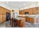 Well-equipped kitchen featuring an island, granite counters, and modern appliances at 11462 E Kora Way, Scottsdale, AZ 85255