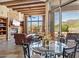 Inviting living room featuring stone fireplace, wood beams, and a wall of windows with mountain views at 11462 E Kora Way, Scottsdale, AZ 85255