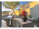 Outdoor kitchen with a stainless steel grill and beautiful landscaping at 11462 E Kora Way, Scottsdale, AZ 85255