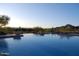 Infinity pool with desert and mountain views at sunset at 11462 E Kora Way, Scottsdale, AZ 85255