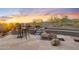 Outdoor patio featuring a waterfall feature and mountain views at sunset at 11462 E Kora Way, Scottsdale, AZ 85255