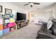 Spacious bonus room featuring a TV, sofa, ceiling fan, and bright natural light at 1151 S Avoca --, Mesa, AZ 85208