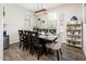 Dining room features a dark wood table, seating for eight, and a modern light fixture at 1151 S Avoca --, Mesa, AZ 85208