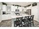 Modern kitchen with white cabinets, a central island with seating, and stainless steel appliances creating an inviting cooking space at 1151 S Avoca --, Mesa, AZ 85208