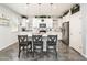 Bright kitchen featuring an island with seating, white cabinetry, and stainless steel appliances, creating a modern space at 1151 S Avoca --, Mesa, AZ 85208