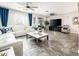 Spacious living room with stylish tile flooring, neutral-toned furniture, and modern ceiling fans for comfort at 1151 S Avoca --, Mesa, AZ 85208