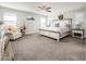 Serene main bedroom suite with king bed, sitting area, and ample natural light from large windows at 1151 S Avoca --, Mesa, AZ 85208