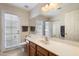 Bathroom featuring a large vanity, tile flooring, and a glass door leading to the backyard at 11805 N 90Th Way, Scottsdale, AZ 85260