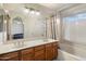 Bathroom featuring double sinks, large mirror, shower over tub, and tile floors at 11805 N 90Th Way, Scottsdale, AZ 85260