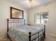 Neutral bedroom showcasing a metal frame bed, a framed mirror, and a window at 11805 N 90Th Way, Scottsdale, AZ 85260