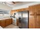 Functional kitchen with wood cabinets, stainless steel appliances, and tile flooring at 11805 N 90Th Way, Scottsdale, AZ 85260