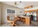Eat-in kitchen with wood cabinets, stainless steel appliances, and a breakfast bar at 11805 N 90Th Way, Scottsdale, AZ 85260