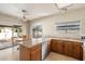 Bright kitchen showcasing an island, wooden cabinets, and a sliding glass door to the outdoor patio at 11805 N 90Th Way, Scottsdale, AZ 85260
