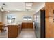 Bright kitchen featuring a kitchen island, tile flooring, wooden cabinetry, and stainless steel refrigerator at 11805 N 90Th Way, Scottsdale, AZ 85260