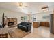 Open concept living room featuring a stone fireplace and access to the kitchen at 11805 N 90Th Way, Scottsdale, AZ 85260