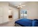 Well-lit main bedroom with ensuite bathroom, sliding glass doors, and a ceiling fan at 11805 N 90Th Way, Scottsdale, AZ 85260