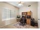 Cozy office space with a large window, built-in shelving, and a comfortable chair at 11805 N 90Th Way, Scottsdale, AZ 85260