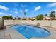 Backyard showcasing a sparkling blue in-ground swimming pool surrounded by a block fence at 11805 N 90Th Way, Scottsdale, AZ 85260